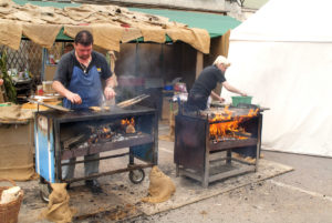 Eggenburg, Austria grilling fish over charcoal