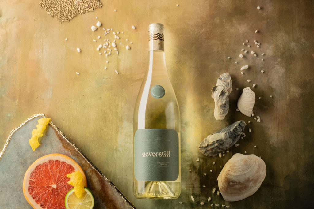  Neverstill Riesling from the Finger Lakes, styled with moss, river stones, dried apricots, and cardamom on marble. Photograph by Meghan Spiro.